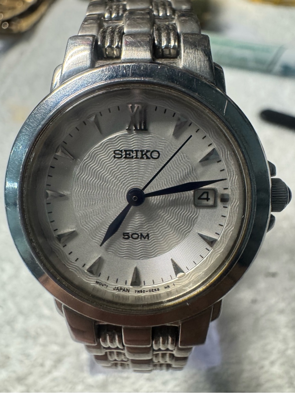 Seiko Silver Watch with Blue Hands and White Dial